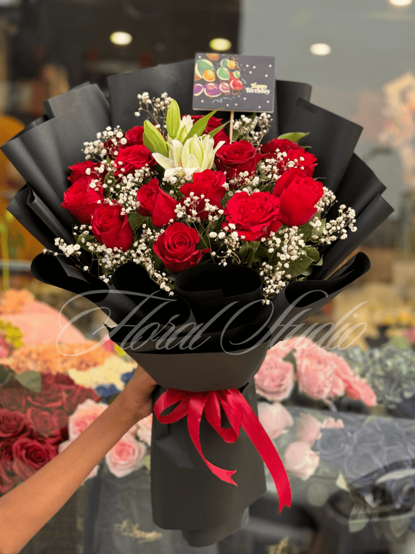 Crimson Charm bouquet with red roses, white lilies, baby’s breath and greenery