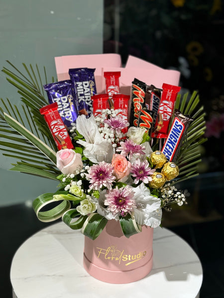 Decadent Delights bouquet with roses, gladiolus, chrysanthemums, gypsum, and assorted chocolates