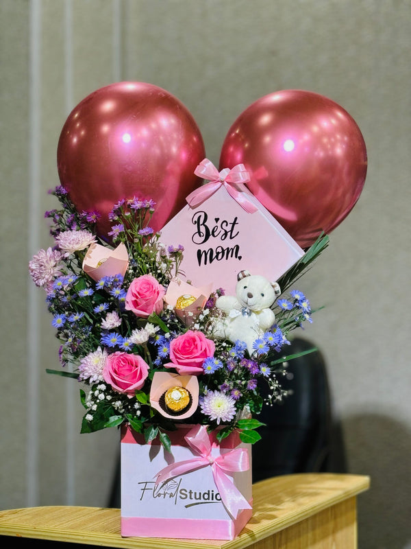 Elegant Surprise Mother’s Day floral box with Ferrero Rocher, teddy bear, pink roses, chrysanthemums, asters, and balloons