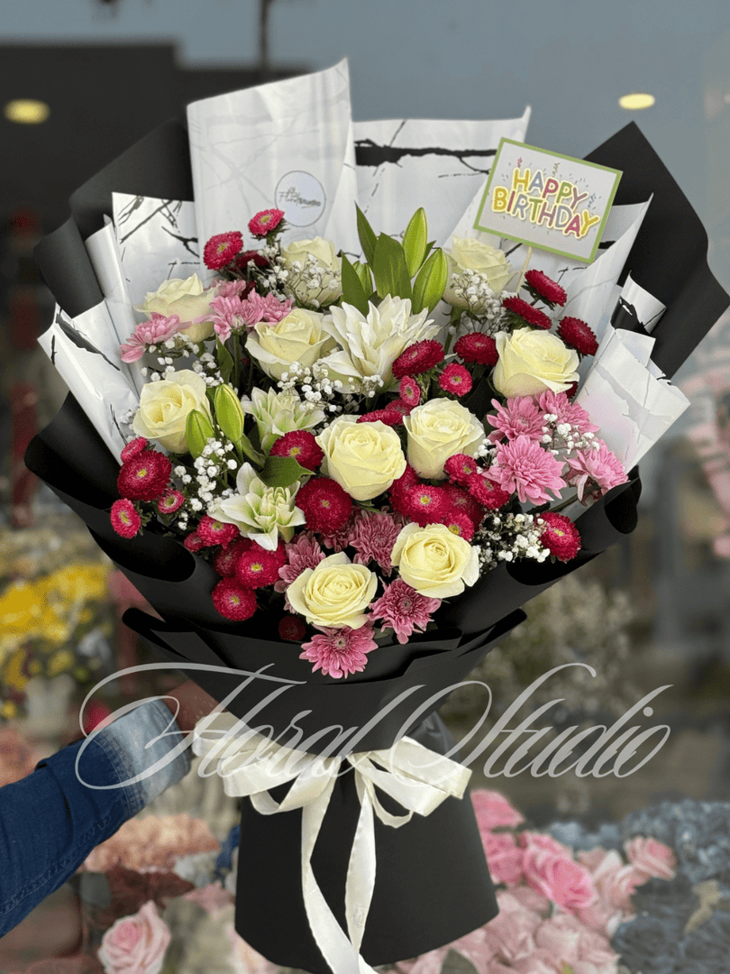 Floral Elegance bouquet with white roses, red daisies, pink chrysanthemums, and baby’s breath