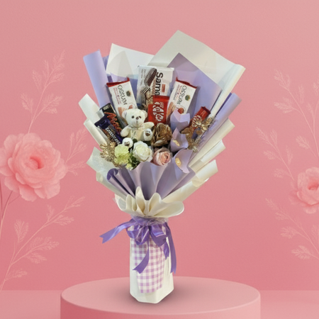Bouquet of snacks and flowers on a pink platform with a pink background