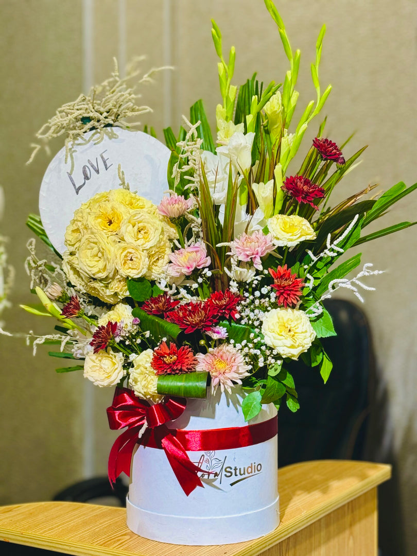 Love Bliss Bouquet with red roses, pink carnations, and white lilies