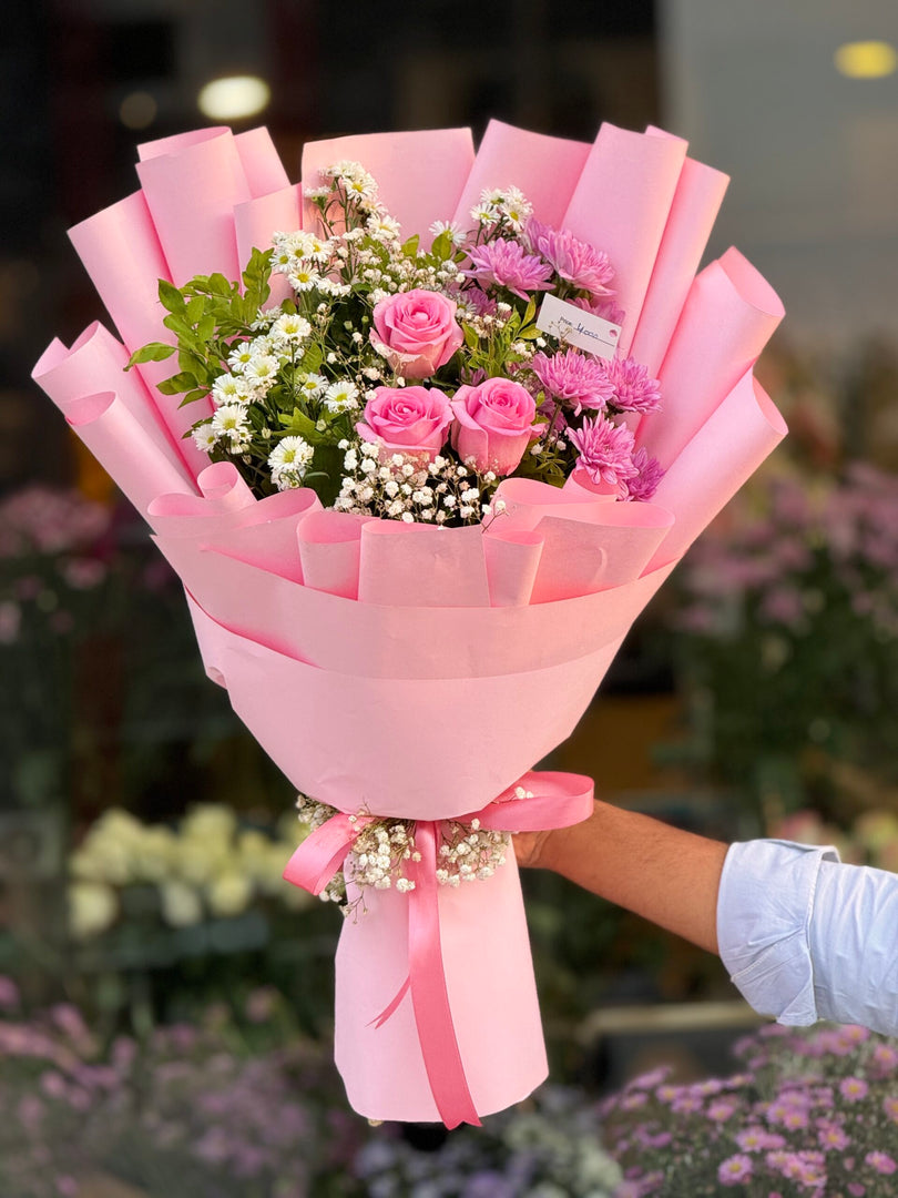 Pink Petal Paradise bouquet with pink roses, chrysanthemums, gypso, and asters
