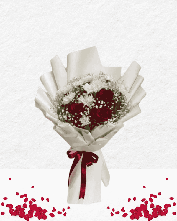 Bouquet of red flowers with white leaves and a red ribbon on a light gray background.
