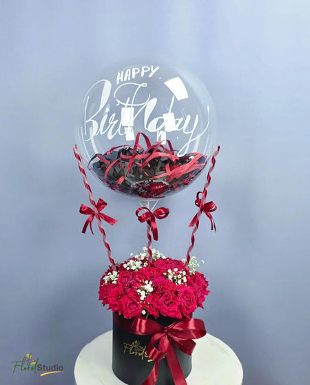 Red Velvet Bloom arrangement with roses, baby’s breath, confetti, and birthday balloon