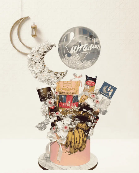 Decorative gift basket with Ramadan-themed items on a white background