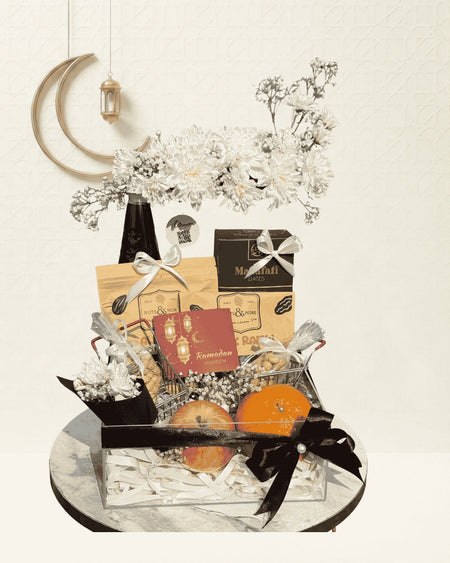 Decorative gift basket with flowers, cards, and a moon lantern on a white background