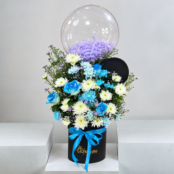 Blue roses and chrysanthemums with a bubble balloon in a black flower box