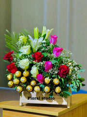 Chocolate Harmony bouquet with roses, lilies, and Ferrero Rocher chocolates

