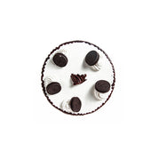 A round ice cream cake with vanilla and chocolate layers, decorated with whole Oreo cookies and chocolate pieces.