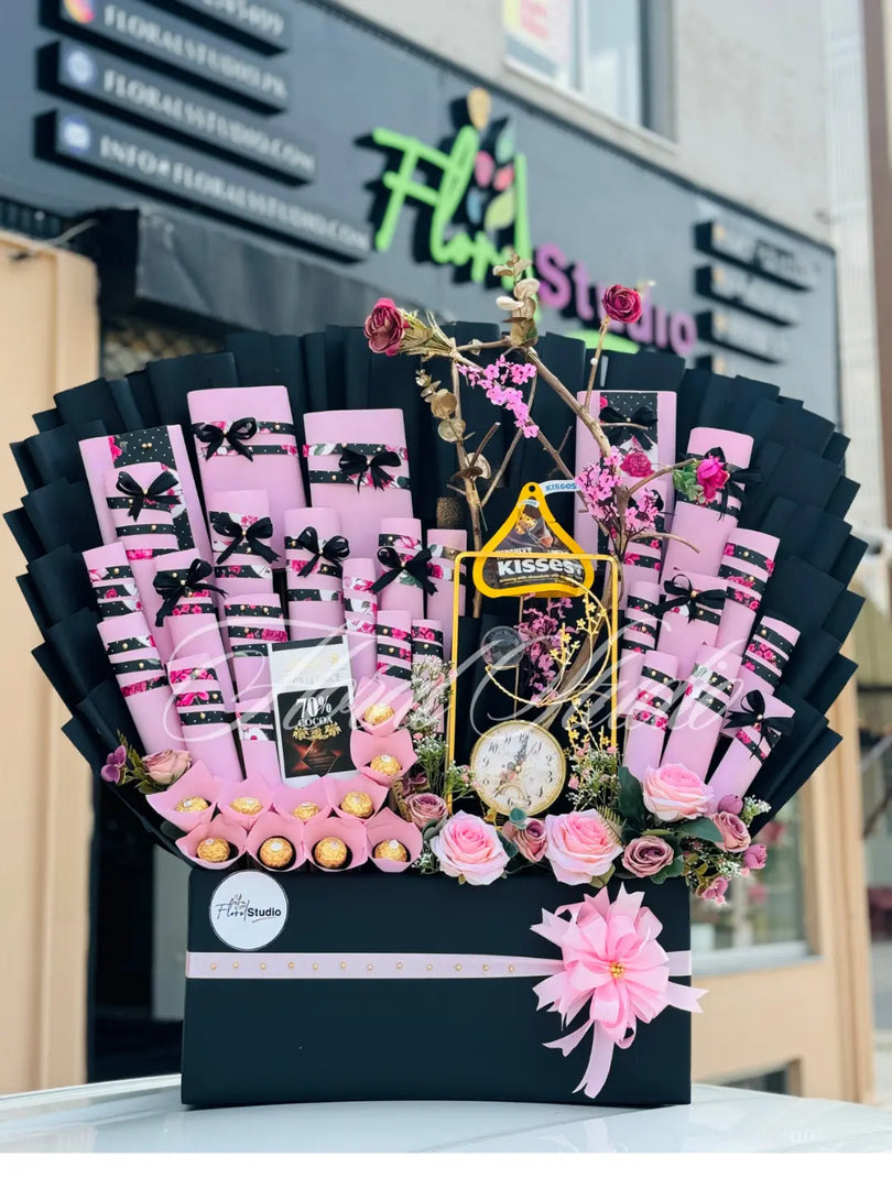 Decorative gift basket with flowers and premium imported chocolate , clock and decoration items .