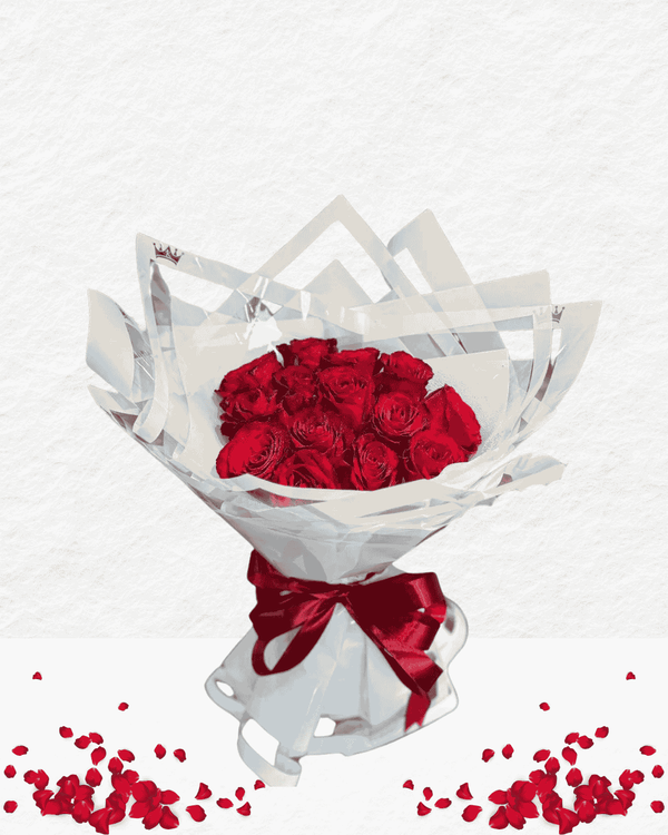 Bouquet of red roses in a white wrap with a red ribbon on a white background