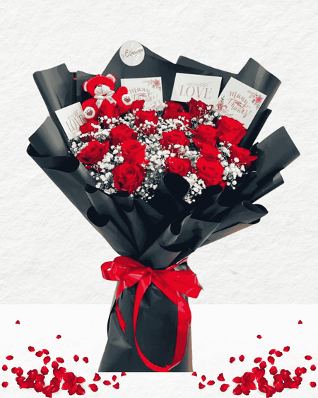 Bouquet of red roses with black wrap and red ribbon on a light gray background