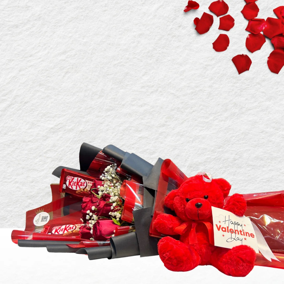 Bouquet of KitKat bars and a red teddy bear with Valentine's Day card on a white background