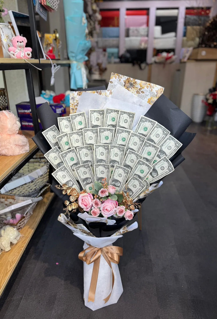 Bouquet made of real dollar note with pink flowers and a gold bow. Money cash bouquet. Custom design bouquet