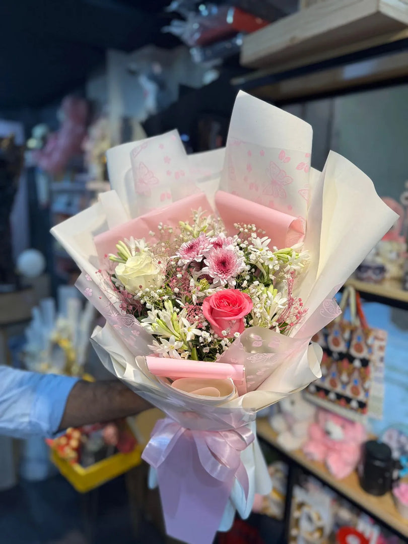 Exotic flower bouquet designed with the colorful imported flowers, white & pink rosses and baby birth