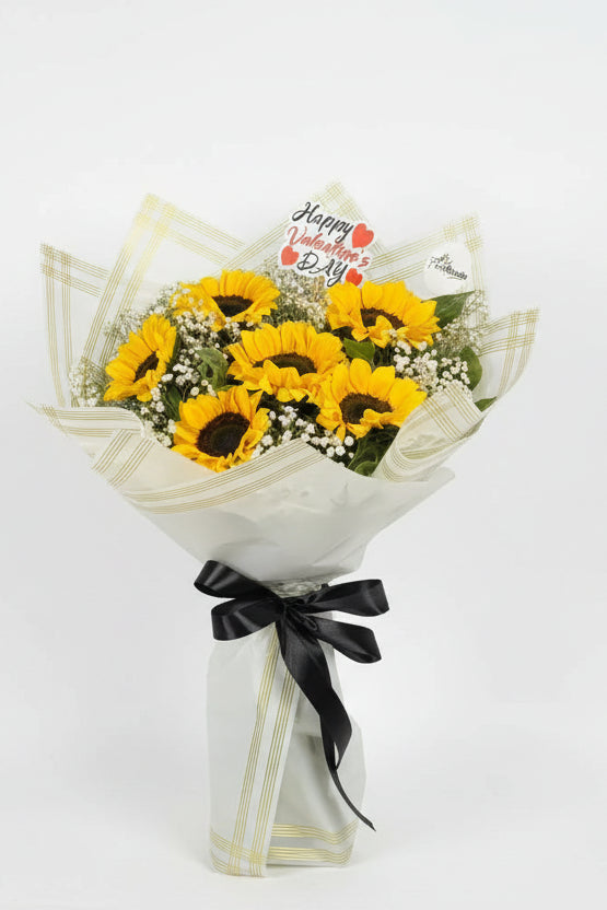 Bouquet of sunflowers with a 'Happy Valentine's Day' card on a gray background. Send flowers to lahore