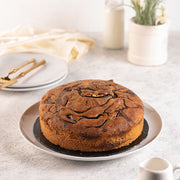 Loaf of almond cake topped with sliced almonds