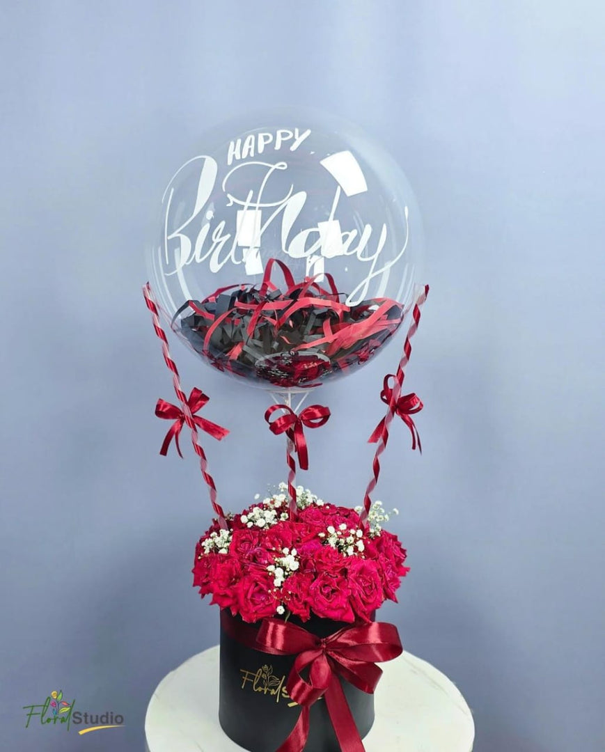 Red Velvet Bloom arrangement with roses, baby’s breath, confetti, and birthday balloon  

