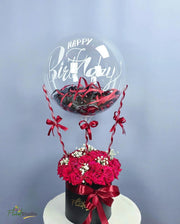 Red Velvet Bloom arrangement with roses, baby’s breath, confetti, and birthday balloon  

