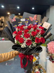 Bouquet of red roses with Cadbury Dairy Milk chocolate bars and a red ribbon. Bouquet designed by top florist in lahore