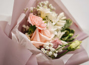 Bouquet of flowers with pink and white colors on a light background
