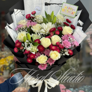 Floral Elegance bouquet featuring white roses, red daisies, pink chrysanthemums, and baby's breath, wrapped in stylish black and white marble paper with a white satin ribbon.