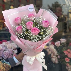 Blush Charm Bouquet featuring fresh pink roses and white baby's breath, elegantly wrapped in pastel pink, available for online flower delivery in Lahore.